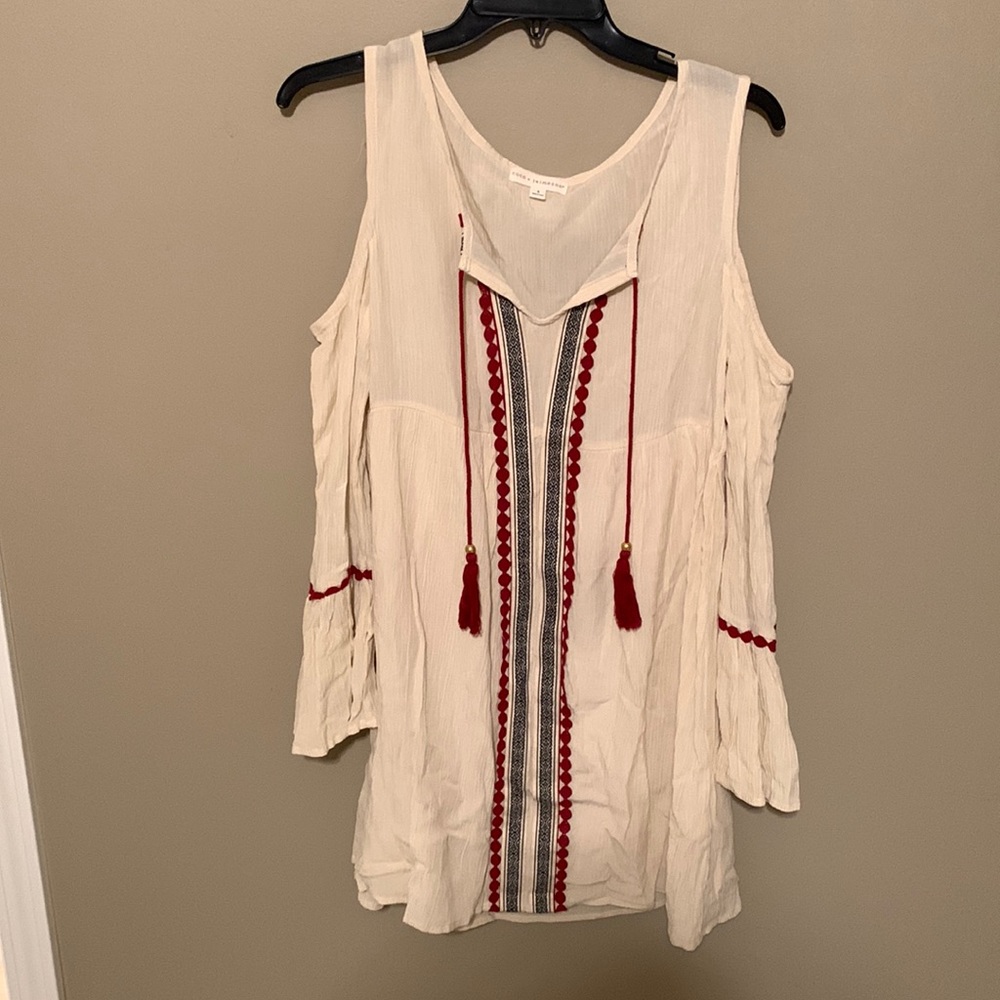 Cream dress with black and red design in front. Cutout sleeves. Size small